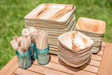 Collection of birch wood utensils and palm leaf dishes